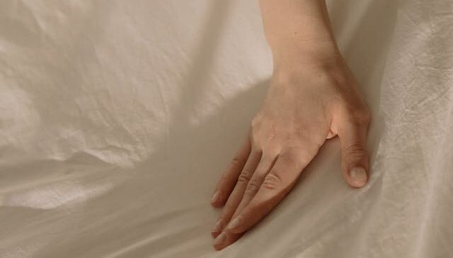 Hand on sheet