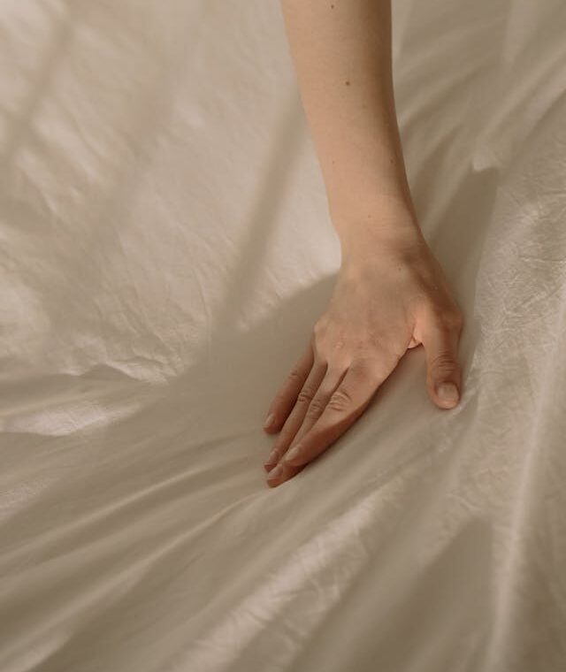 Hand on sheet