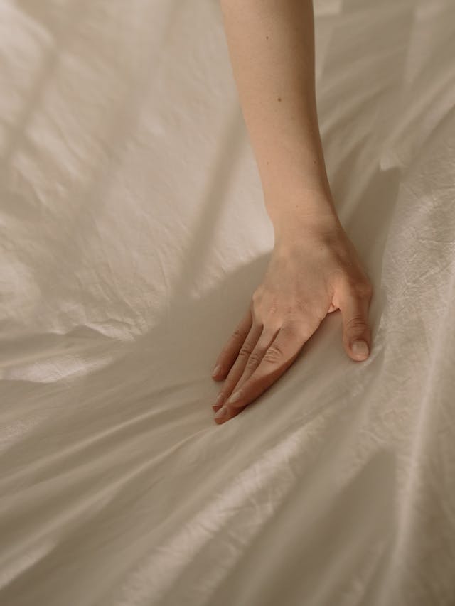 Hand on sheet